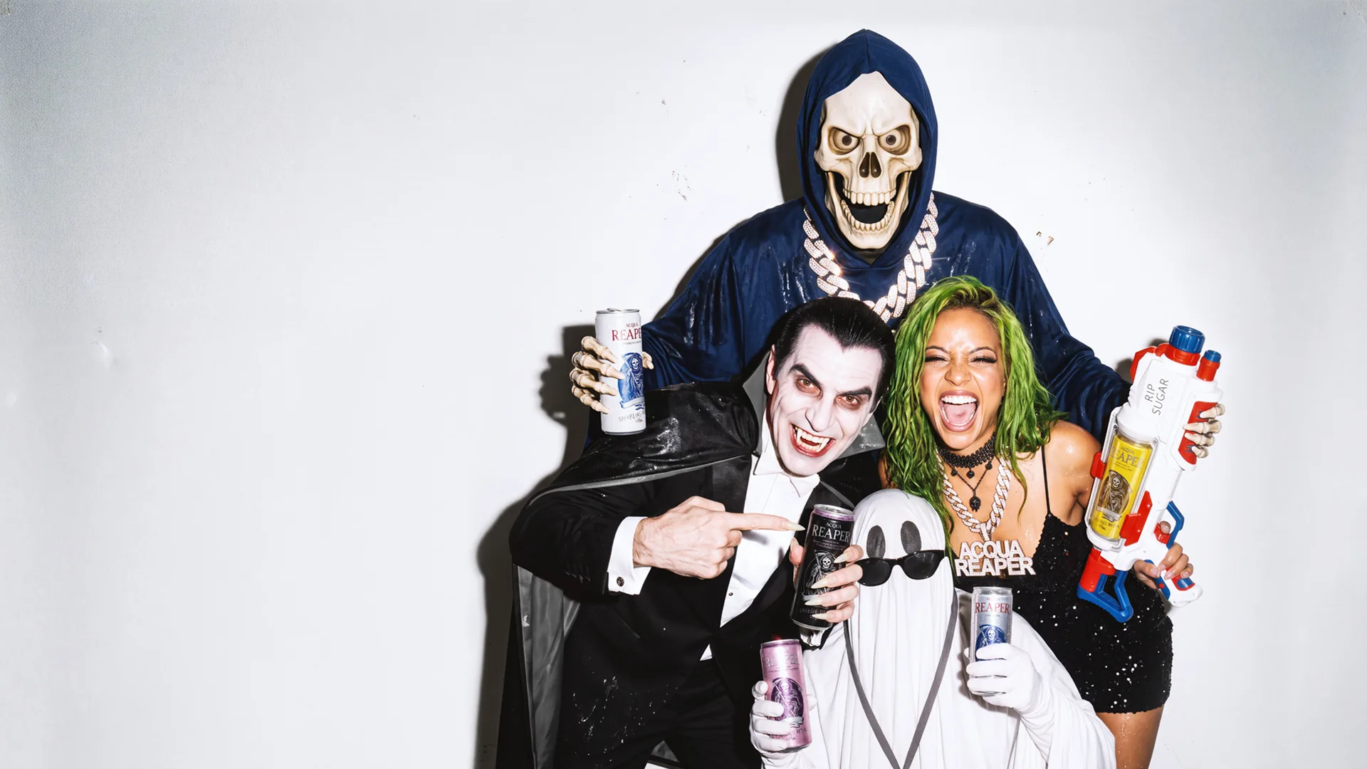 The Reaper gang are celebrating: Reaper, Dracula, the Ghost and the woman with green hair, all holding ACQUA REAPER cans